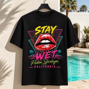 Black Stay Wet Hot Lips and Triangles graphic tee displayed by a Palm Springs pool